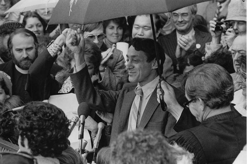 Harvey Milk surounded by people