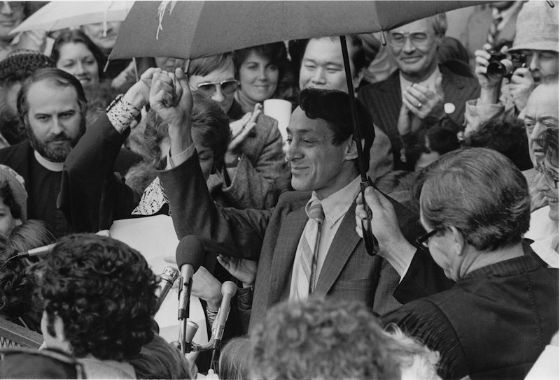 Harvey Milk surounded by people