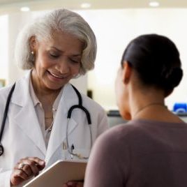 Older female doctor with younger female patient