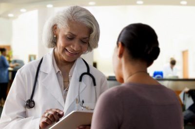 Older female doctor with younger female patient