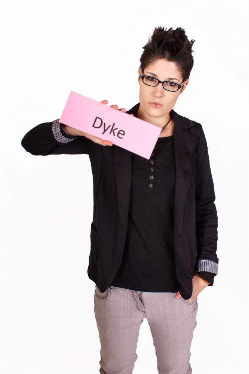 Woman holding a sign "Dyke"