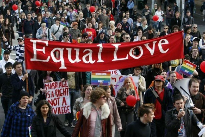 Marriage Equality Protester carrying an Equal Love banner