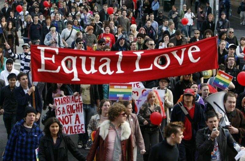 Marriage Equality Protester carrying an Equal Love banner