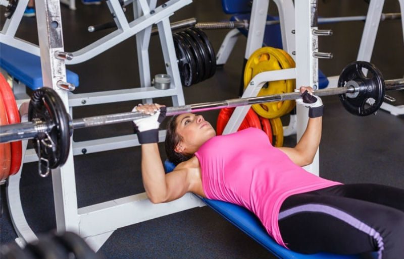 woman on a bench press