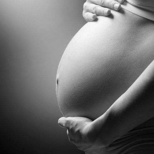 black and white photo of pregnant woman