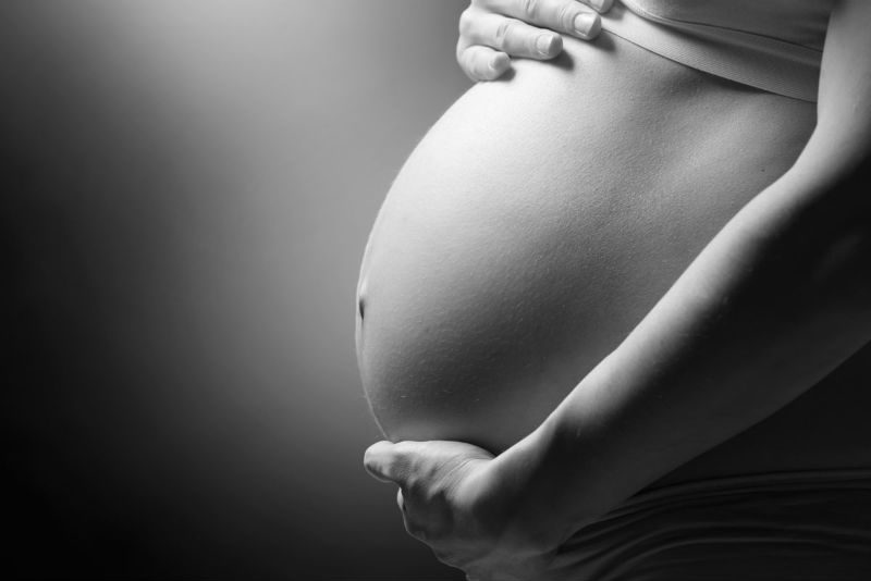 black and white photo of pregnant woman