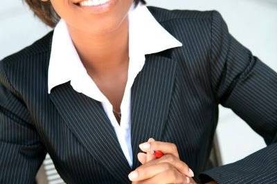 Business Woman sitting on desk smiling