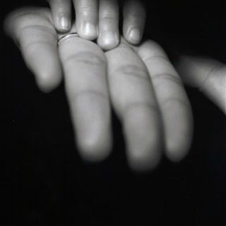 black and white photo of child and adult hand