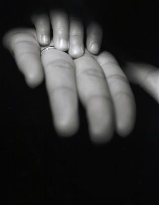 black and white photo of child and adult hand 