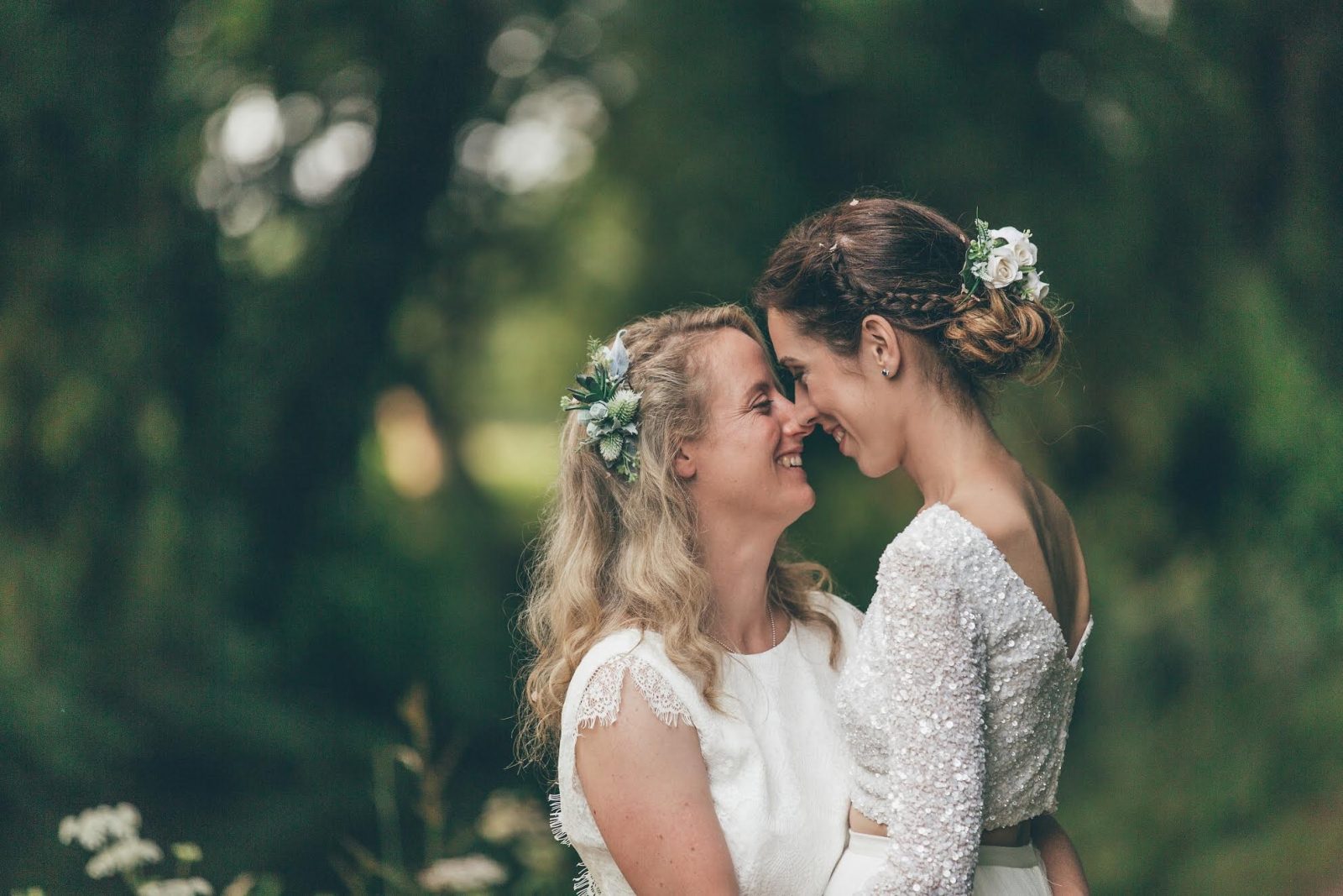 2 lesbian brides in white holdong each other