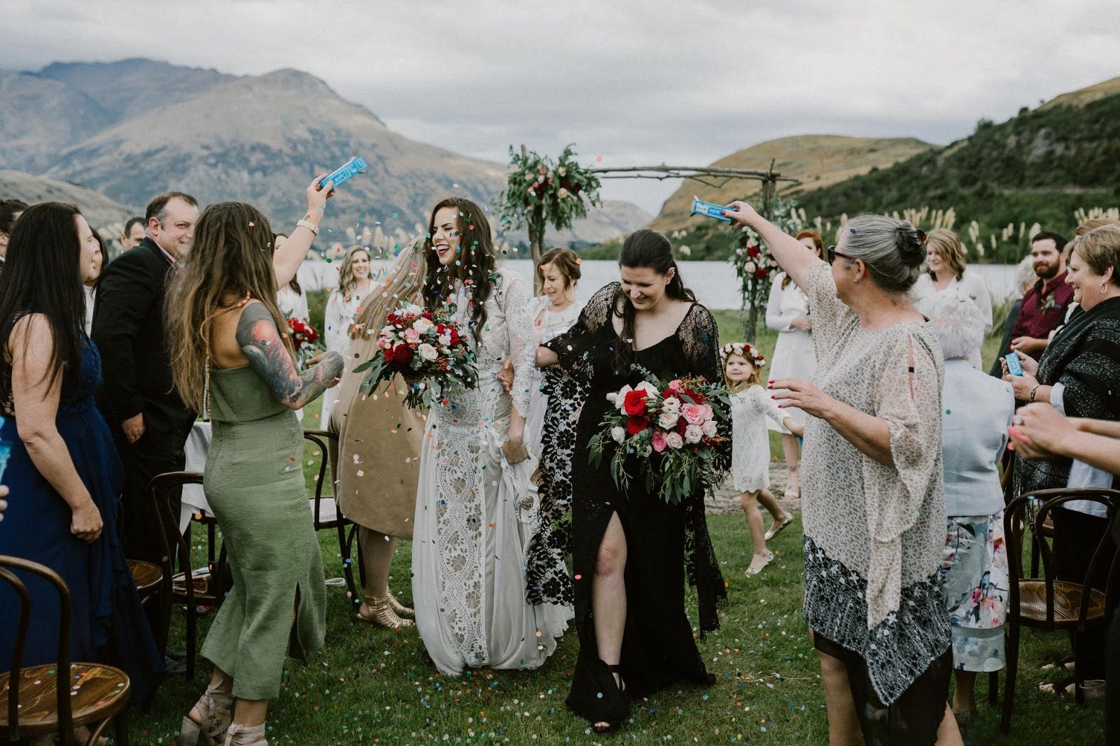 lesbian wedding photo next to a lake 