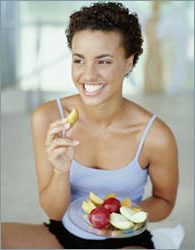 skinny woman eating fruit 