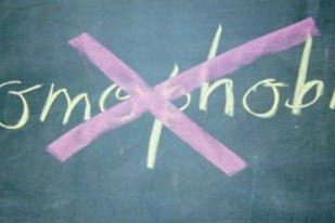 homophobia written on a blackboard