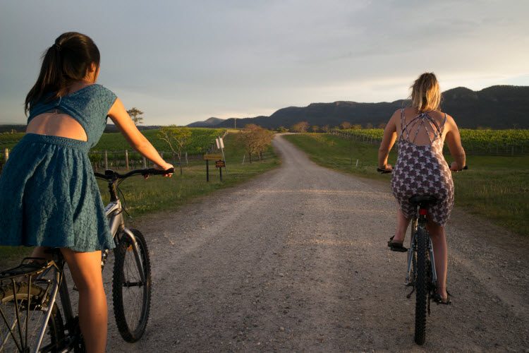 2 women riding a pushbike in the hunter valley
