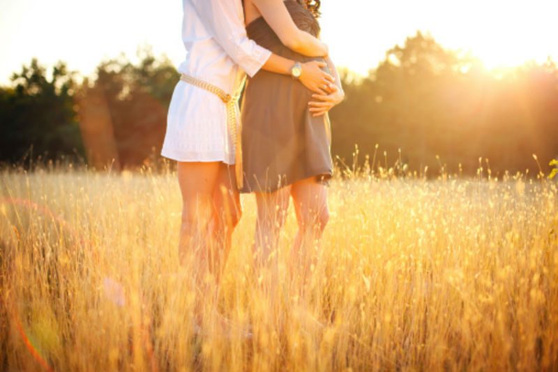 2 women standing in corn field