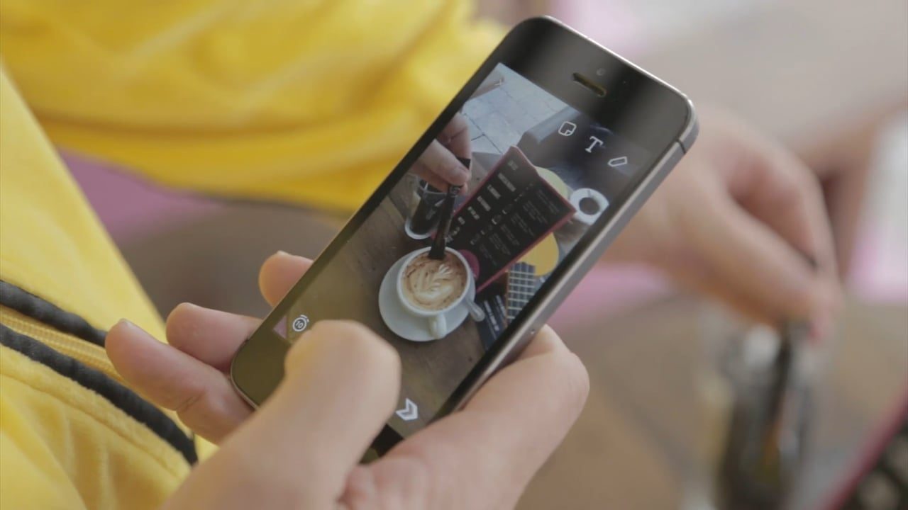 womans hand using a mobile phone