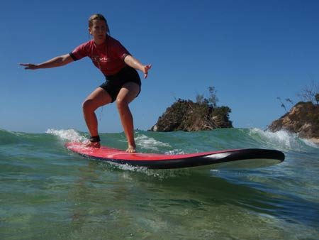 woman standing on surf board