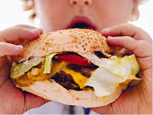 woman biting into hamburger