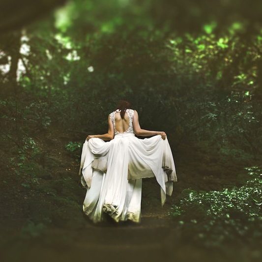 woman in white gown in forest