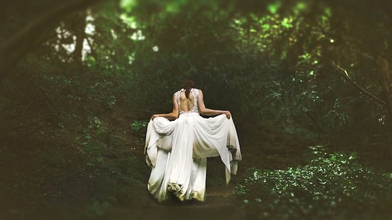 woman in white gown in forest