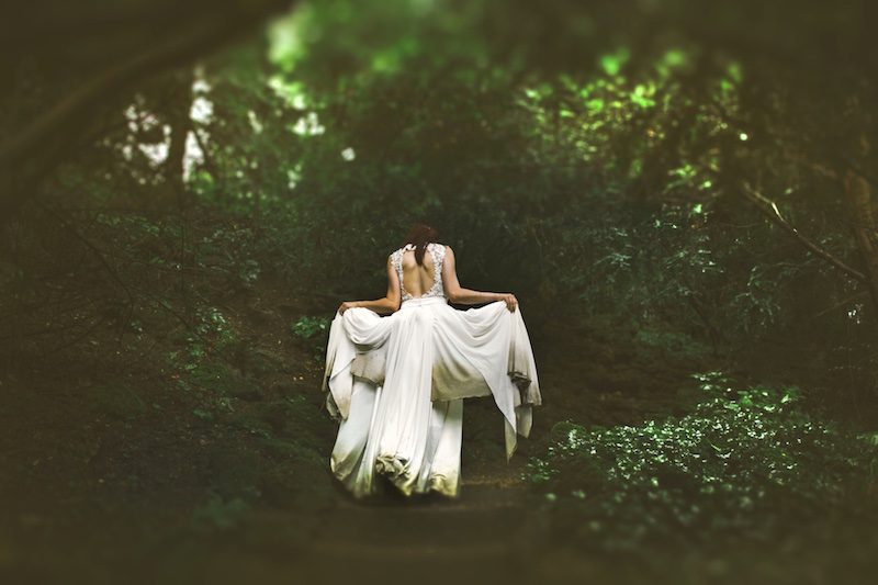 woman in white gown in forest