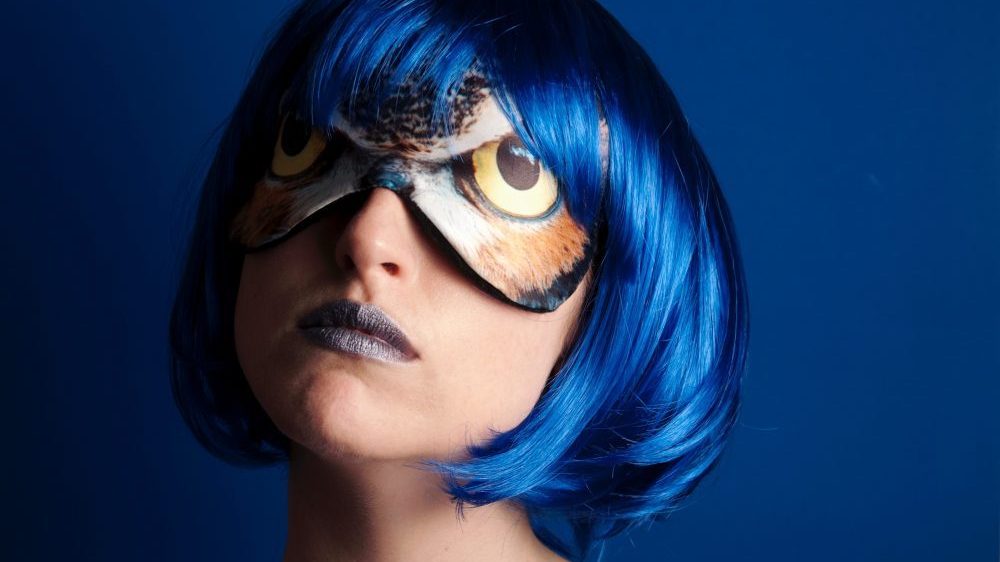 woman with blue hair and mask